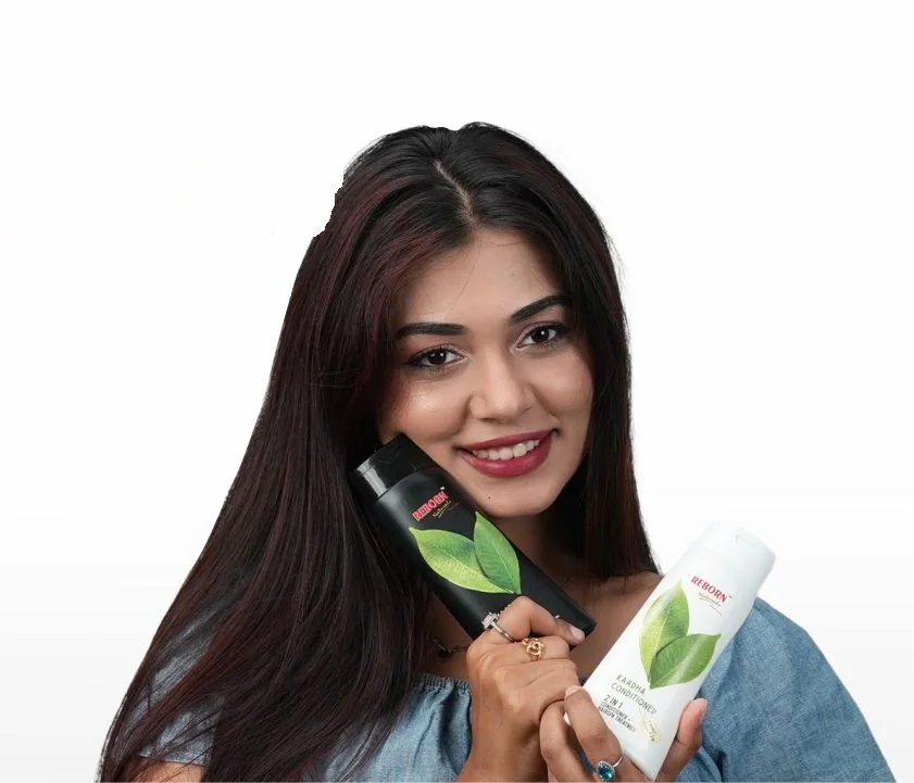 Smiling woman holding Kaadha Shampoo and Conditioner